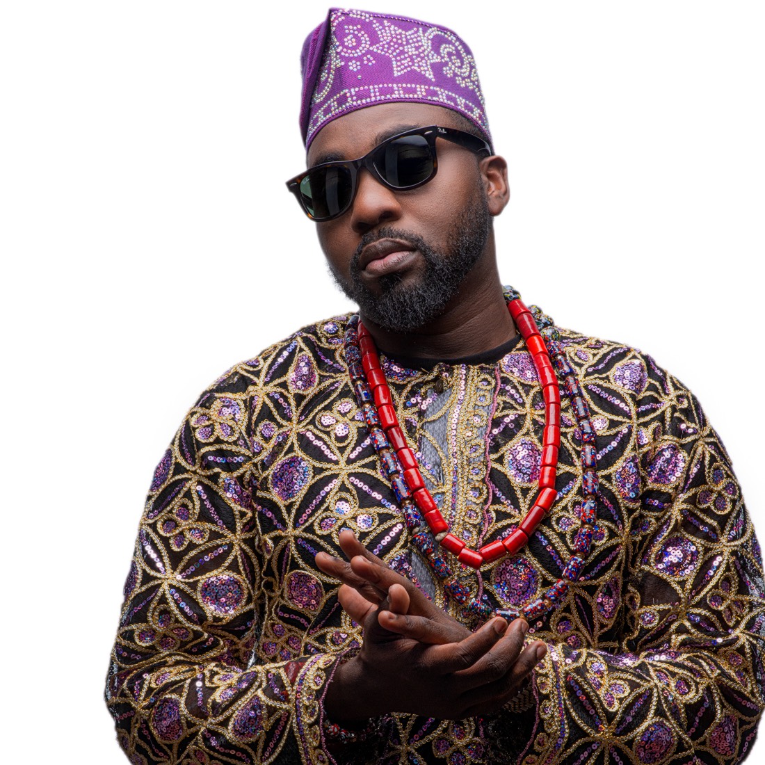 DJ OMG PRINCE in a purple and gold embroidered agbada with a beaded necklace and sunglasses