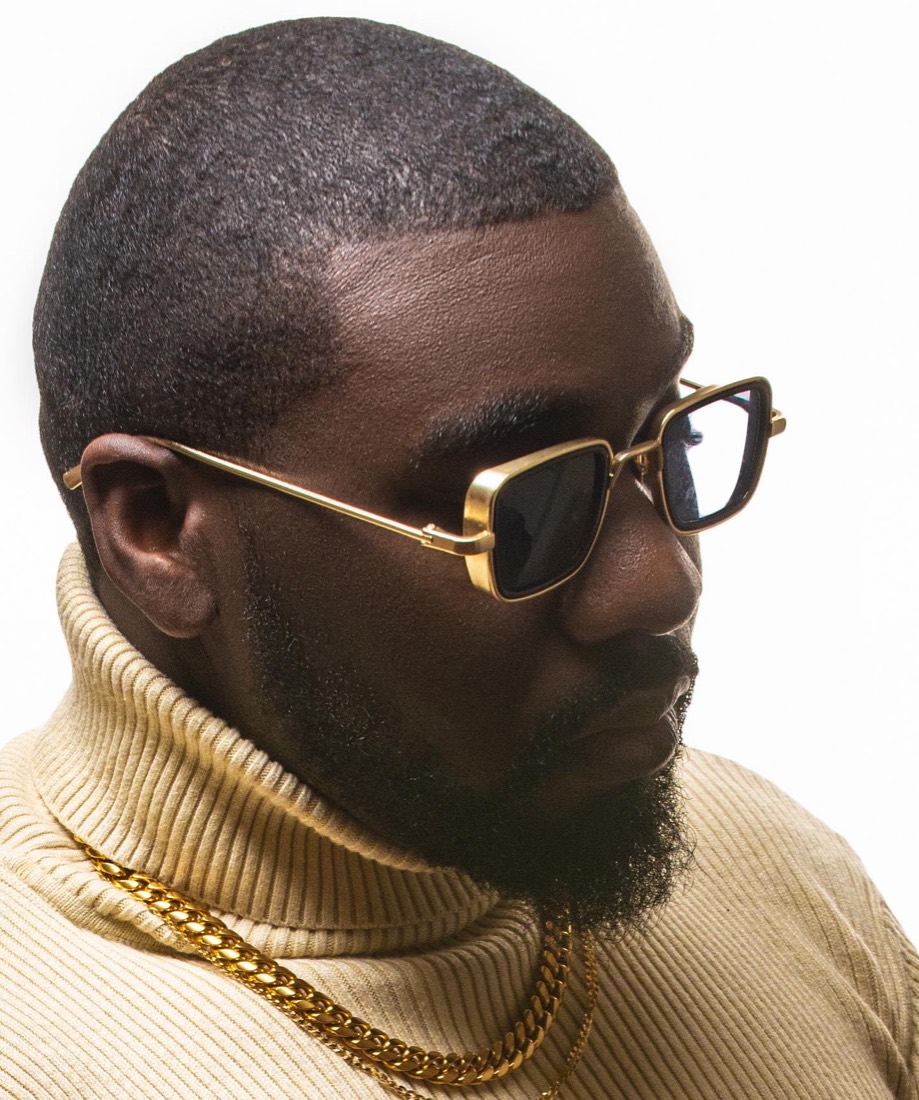 Profile portrait of DJ OMG PRINCE in gold-framed sunglasses and a cream turtleneck
