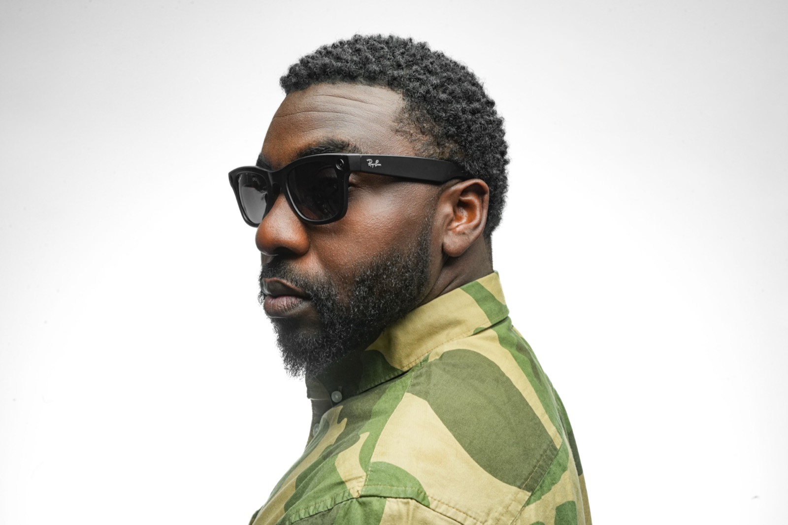 Profile portrait of DJ OMG PRINCE in sunglasses and a camo shirt